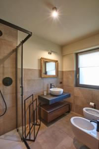 a bathroom with a sink and a toilet and a mirror at Nid Des Alpes - Courmayeur in Courmayeur