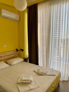 a bedroom with a bed with two towels on it at Villa Sangria in Skala Marion +25 photos