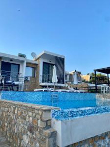 a swimming pool in front of a house at Villa Sangria in Skala Marion