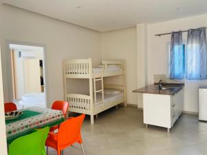a small room with a table and a bunk bed at Donald Hotel in Vlorë