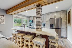 a kitchen with a large island with stools at Bee Branch 05 in Sugar Mountain