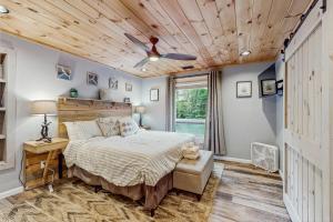 a bedroom with a bed and a wooden ceiling at Bee Branch 05 in Sugar Mountain