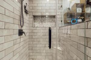 a bathroom with a shower with white tiled walls at Bee Branch 05 in Sugar Mountain +15 photos
