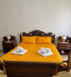 a bedroom with a bed with two towels on it at La CASA DEL SOLE in Paceco
