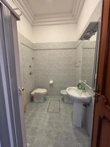 a bathroom with a toilet and a sink at La CASA DEL SOLE in Paceco +30 photos