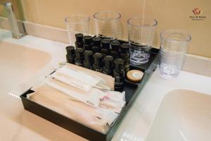 a box on a counter with glasses and water at Here & Home Villa Vườn Vua in Kon Rung (1)