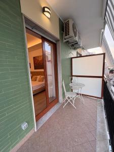 a balcony with a table and a room with a bed at Domus Matronae in Castellammare di Stabia