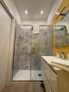 a shower with a glass door in a bathroom at Domus Matronae in Castellammare di Stabia