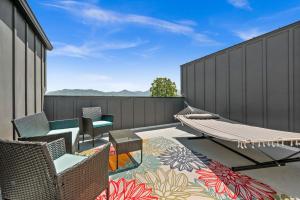 a patio with chairs and a hammock and a fence at SLC Townhome King BD 2 Car Garage in Salt Lake City