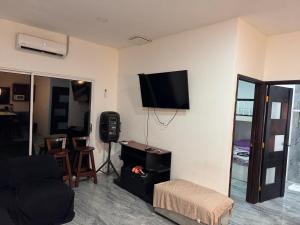 a living room with a flat screen tv on a wall at Rancho El Valle in Acajutla