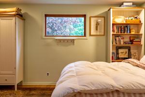 a bedroom with a white bed and a window at Quiet place with easy access NYC in River Edge