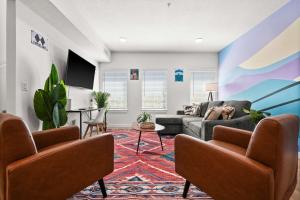 a living room with a couch and a table at SLC Ski Lodge 2BR Townhome King Garage in Salt Lake City +37 photos