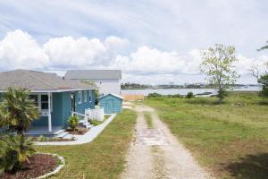 a house with a road leading to a house at Bay Breeze Retreat in Morehead City