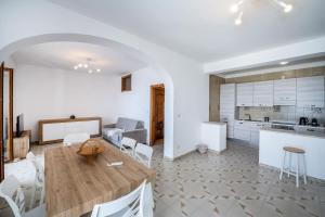 a kitchen and living room with a wooden table and chairs at Villa Rosy in Amalfi