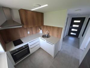 a small kitchen with a sink and a stove at En hribček in Ptujska Gora +47 photos
