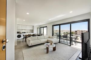 a living room with a couch and a table at Sunny Apartments in Cabanas de Tavira