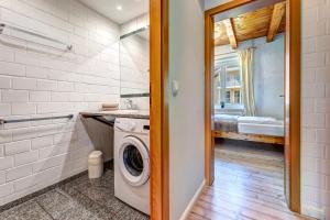a bathroom with a washer and dryer in a room at Ferienhaus Odin in Bansin