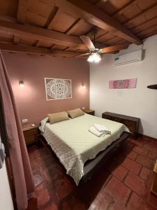 a bedroom with a bed and a ceiling at Hostal Rustyk in Cafayate