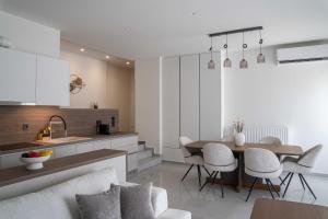 a kitchen and living room with a table and chairs at Nireas Blue Balcony by Raise in Áno Váthia