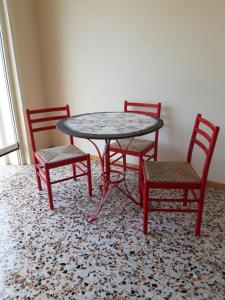 a table and two chairs and a table at Cascina Nuova in Mombasiglio