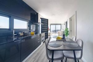 a kitchen with a table and chairs in a room at Ocean Valley by Mth in Ribeira Brava