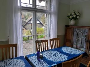 a dining room with a table and a window at Gable Lodge Guest House in Lynton