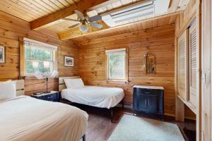 a bedroom with two beds and a ceiling fan at Easton Escape a notch above in Sugar Hill