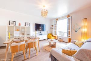 a living room with a table and a couch at Le Rangiroa, 4 people, 5 min to Disneyland Paris in Marne-la-Vallée