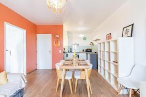 a dining room with a table and a living room at Le Rangiroa, 4 people, 5 min to Disneyland Paris in Marne-la-Vallée