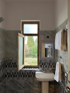 a bathroom with a sink and a window at Otsal Villa in Leh