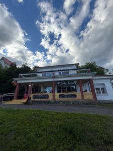 Un restaurante con un edificio con cielo. en PoĽská KrČma, en Vysoké Tatry