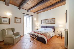 a bedroom with a bed and a chair in it at Palazzo Marigliano in Naples