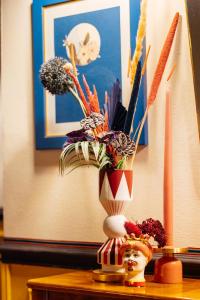 a vase with flowers in it on a table at JOIVY Together Florence Secret Nest in Florence
