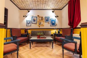 a waiting room with a couch and chairs at JOIVY Together Florence Secret Nest in Florence