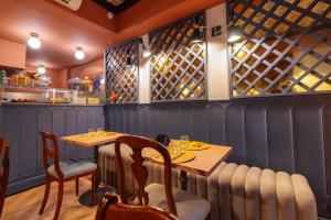 a dining room with a table and chairs in a restaurant at JOIVY Together Florence Secret Nest in Florence