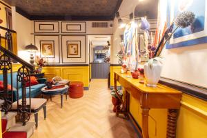 a living room with yellow walls and a table and chairs at JOIVY Together Florence Secret Nest in Florence