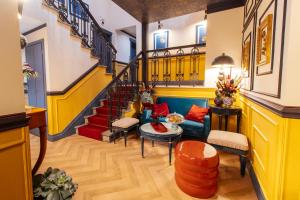 a living room with a blue couch and stairs at JOIVY Together Florence Secret Nest in Florence