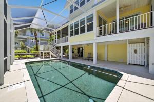 a swimming pool in front of a house at Sea Oats Oasis in Sanibel