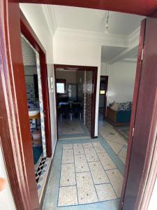 a hallway leading to a room with a bedroom at Yahya oulidia in Oualidia