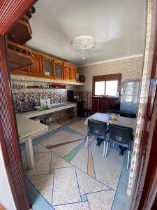 a kitchen with a table and chairs in a room at Yahya oulidia in Oualidia