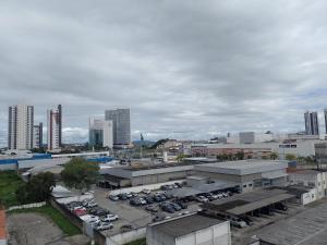 a city with cars parked in a parking lot at Flat especial Black in Campina Grande