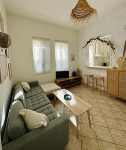 a living room with a couch and a table at Casa Sasa in Porto Cesareo