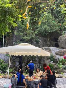 a group of people sitting around a table under a tent at Tropical Forest Homestay 