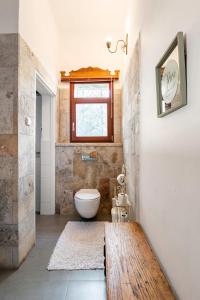 a bathroom with a toilet and a window at Quiet and Spacious Luxury Apartment with Splendid View between Carmel and Downtown in Haifa +20 photos