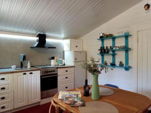 a kitchen with a table with a vase on it at Cabaña El Antojito in Cabanes
