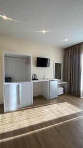 a living room with a flat screen tv on a table at Hotel Adriatik Ksamil in Ksamil
