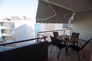a balcony with a table and chairs and the ocean at Drosia Apartments in Lefkandi in Lefkandi Chalkidas