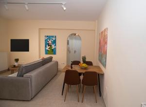a living room with a couch and a table at Drosia Apartments in Lefkandi in Lefkandi Chalkidas