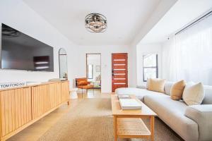 a living room with a couch and a table at 2 Units Oasia Villa w terrace 12 pax in Los Angeles