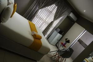 a bedroom with a teddy bear sitting on a bed at U And I GuestHouse in Empangeni